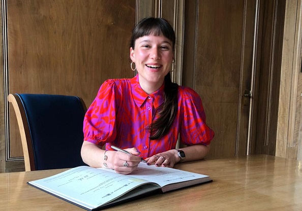 Cllr Gilderdale at a desk with notebook