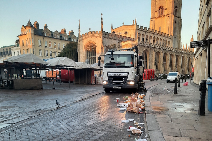 A lorry sweeping up litter by the market square