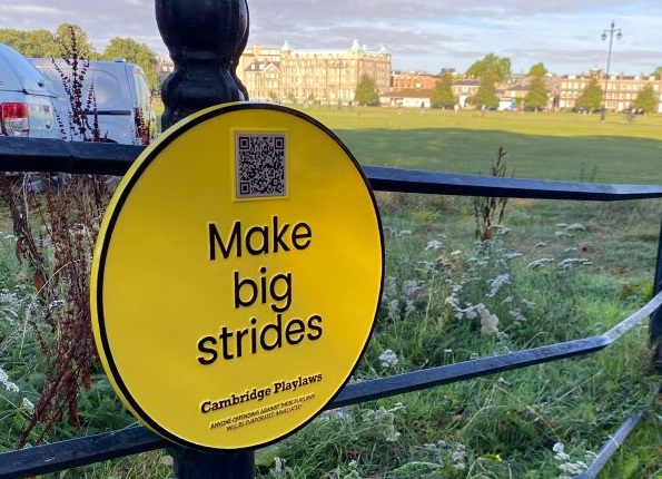 Yellow plaque fixed to railings asks people to 'Make big strides'