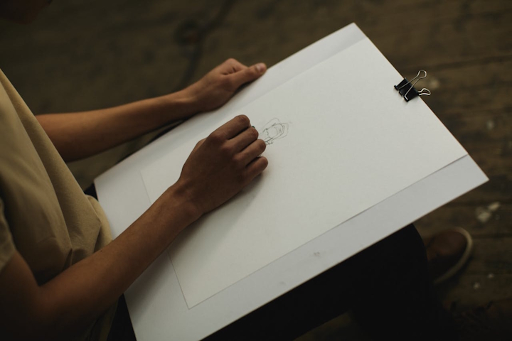Person drawing on plain paper
